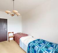 A room with a bed, chair, and wardrobe in a 2-room apartment.