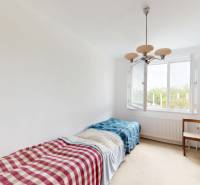 A room with two beds, a wardrobe, and a window in a 2-room apartment.