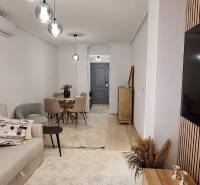 Bright living room with a sofa, table, and modern decor in a 3-room apartment.