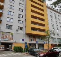 Apartment building in Bratislava on Antolská Street with parking and a children's playground.