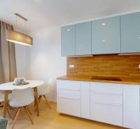 A section with a dining table and a kitchen unit in a 3-room apartment.