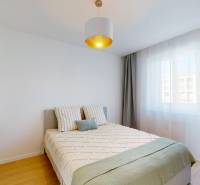 Bedroom with a bed, curtains, and a table in a 3-room apartment.