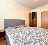 A bedroom with a double bed and a wooden wardrobe in a 3-room apartment.