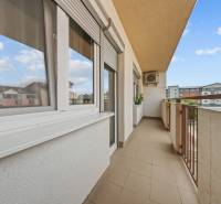 The balcony of a 2-room apartment on Dona Sandtner Street in Pezinok with a view of the surroundings.
