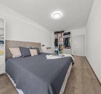 Master bedroom with a built-in wardrobe and a bookshelf in a 2-room apartment.