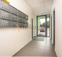 The entrance hall of an apartment building in Galanta with mailboxes on the side wall.