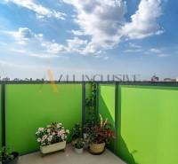 A balcony with flowers and a view of the city in Sereď, Galanta Street, 2-room apartment.