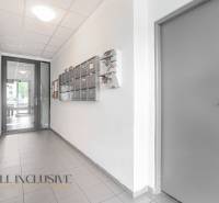 Hallway with mailboxes and doors in a 2-room apartment, bright atmosphere.