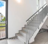 Staircase and parking lot in an apartment building in Galanta, Sereď, with children's bicycles.