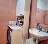 Bathroom and 3-room apartment with a washing machine in a compact space with cabinets.