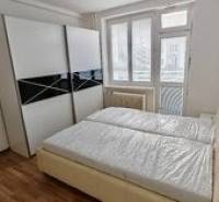 Bedroom with a double bed and a large wardrobe in a 2-room apartment. Verified member of the real estate association.