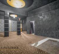 Dark commercial spaces with geometric patterns on the wall and ceiling.
