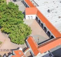 Aerial view of commercial premises with red roofs, greenery, and trees in Dunajská Streda.