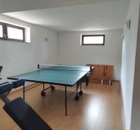 Ping pong table and exercise machine in a family house.
