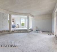 Interior of an incomplete family house with open space and empty floor.