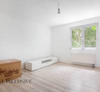 A bright room with a white cabinet and a cardboard box in a family house.