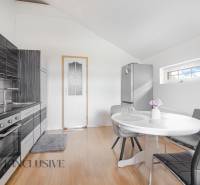 A kitchen in a family house, modern furnishings, dining table, and stylish kitchen unit.