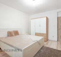 Bedroom in a family house with a bed, wardrobe, and neutral interior design.