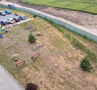 Parking lot and children's playground next to the residential building on Suchoňova Street in Poprad.