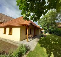 A family house on Atletická Street in Biely Kostol surrounded by a garden and trees.