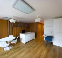 A kitchen in a family house with wooden floors and white furniture.