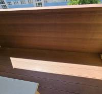 Comfortable balcony with wooden flooring and pebbles in Zvolen, 2-room apartment.