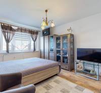 A bedroom in a 2-room apartment with a wardrobe, television, and decorated with flowers.