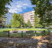 Playground with benches and high-rise buildings on Pražská Street in Košice - West district.