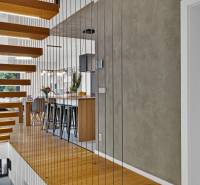 Wooden railing with a view of the kitchen and adjacent bathroom in a family house.