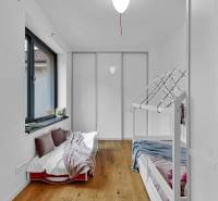 Children's bedroom with a bunk bed and a large window in a family house.