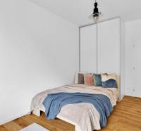 A bedroom with a single bed, wooden floor, and a combination of muted colors in a family house.