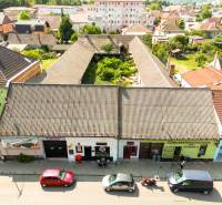 Unusual properties on P. O. Hviezdoslav Street in Nové Mesto nad Váhom, surrounded by houses.