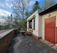 A cottage on Sychrov Street in Beckov with an outdoor seating area by the table and chimney.
