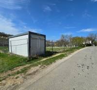 A container on the street, surrounded by plots suitable for living, with a side road to Krajné.