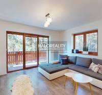 A bright living room with a large window, a sofa set, and wooden flooring in a 3-room apartment.