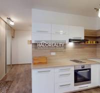 A kitchen in a 3-room apartment with a built-in kitchen unit and a built-in wardrobe, wooden floors.