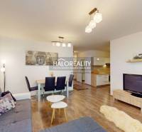 Living room in a 3-room apartment with a sofa, dining table, and television.