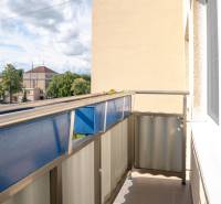 A balcony with a view of the surrounding houses and greenery in Nova Dubnica, 2-room apartment.