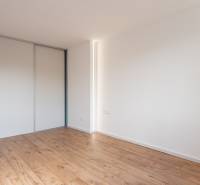Spacious room with wooden floor and built-in wardrobe in a 2-room apartment.