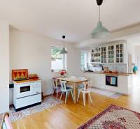 Interior of a cabin with a kitchen, wooden floors, and cozy decorations.