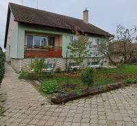 A family house in Levice with a landscaped garden and a paved access road.