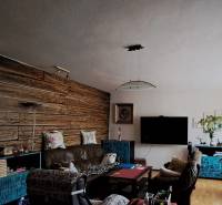 Living room in a family house with a stylish wooden wall and comfortable seating.