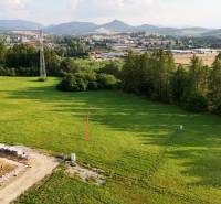 Panoramic view of residential building plots in Kľače with visible power pylons.