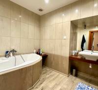 Bathroom in a 2-room apartment with a bathtub and ceramic tiles.