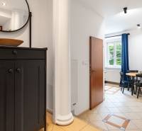 Hallway with a black sideboard and a dining area in a 2-room apartment.
