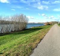 A view of the river by the cycle path in Veľké Kosihy, nature and blue sky.