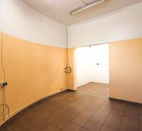 Interior of commercial premises with orange walls and brown flooring.
