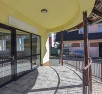 Exterior of commercial premises on Slovenského národného povstania Street in the town of Vrbové, covered terrace.
