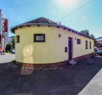A yellow round building between residential houses on Slovenského národného povstania Street in Vrbové.