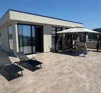 A recreational apartment in Ksamil with a terrace, sunbeds, and a garden gazebo for relaxation.